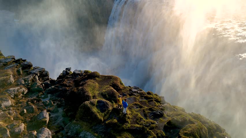 Witness the powerful rush of Dettifoss, Icelands most stunning waterfall. a couple on vacation in Iceland