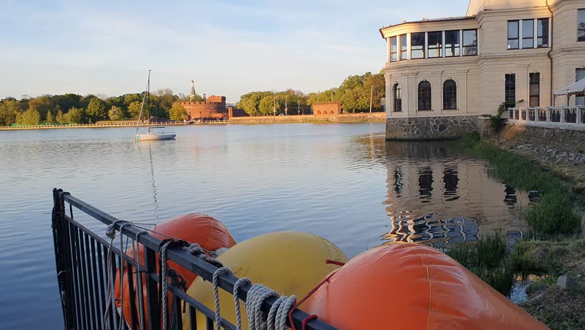 pier on a large lake, motorsport on the river, yacht pier, fishing boats, european architecture