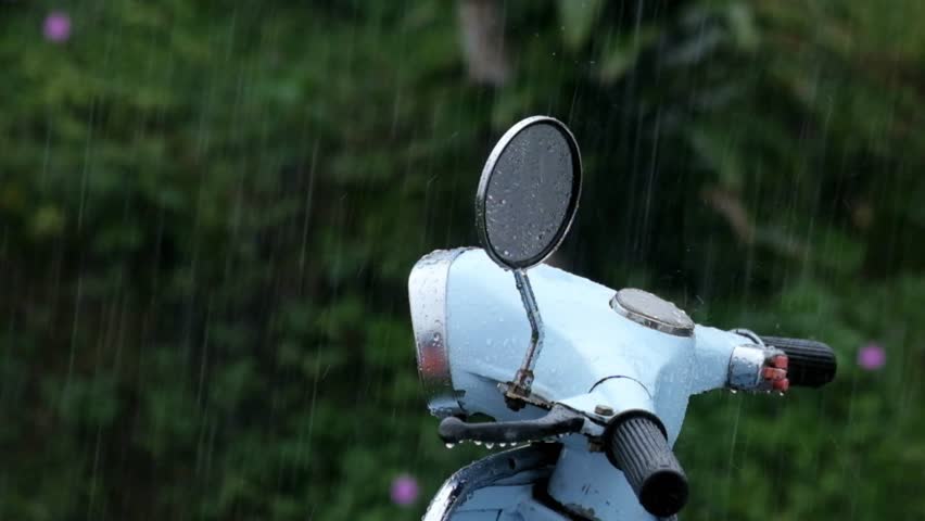 Scooter motorcycle handlebars caught in the rain. Climate and weather concept. Footage 4K,60Fps