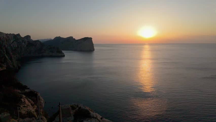 Golden sunset over the calm mediterranean sea from the famous cape formentor viewpoint in mallorca, balearic islands, spain