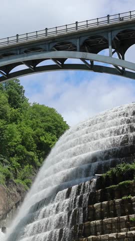 water cascading down waterfall at croton dam (man made and natural drinking water reservoir) westchester new york landmark with old bridge (tourism travel hiking destination) nature landscape