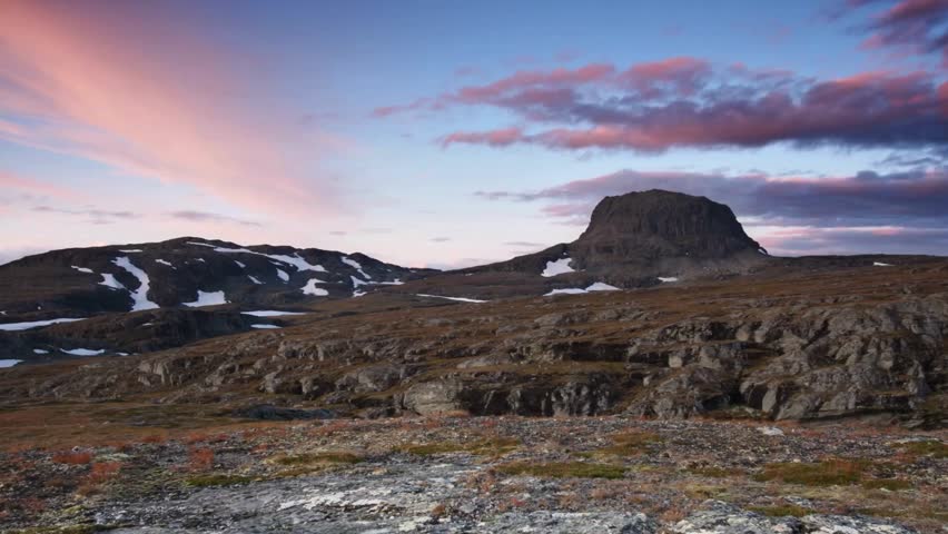 Dramatic Sunset over Mountainous Landscape with Pink Clouds