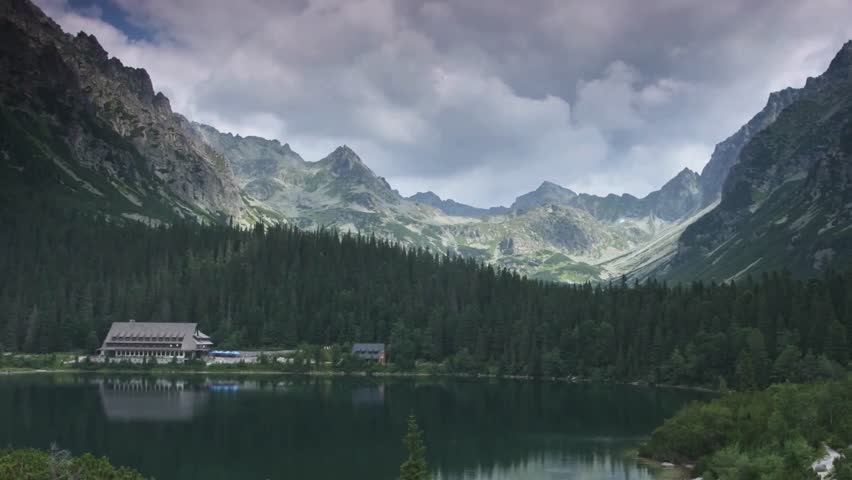Majestic Mountain Lake Landscape with Dark Clouds and Forest