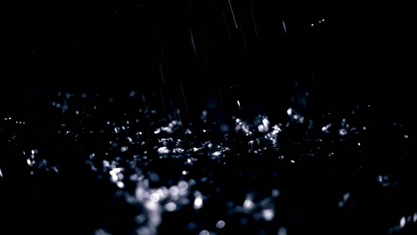 Raindrops Falling on Dark Water Surface at Night