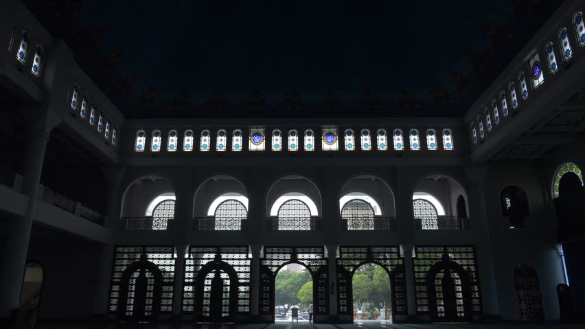 A silhouette of the arched Windows inside al-Akbar National Mosque Surabaya in eastern Java, Indonesia, Southeast Asia.