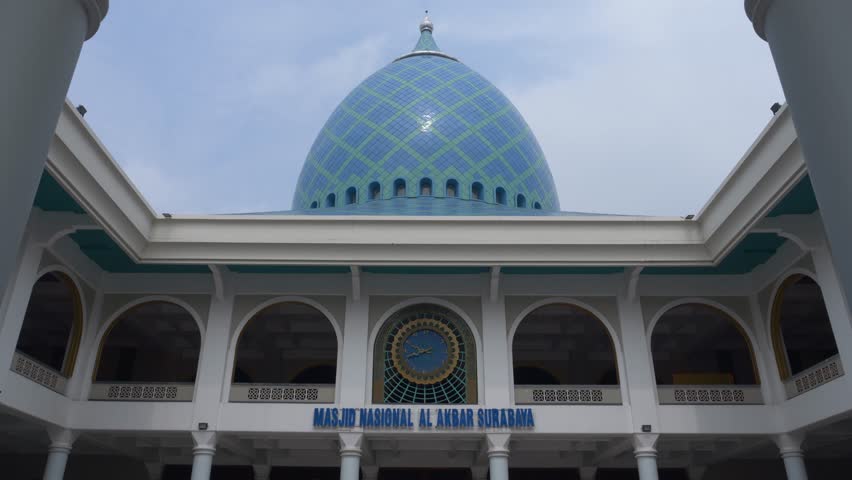 The blue circular dome of al-Akbar National Mosque Surabaya in Southeast Asia, Indonesia. The text translation that appears in the picture: al-Akbar National Mosque Surabaya.