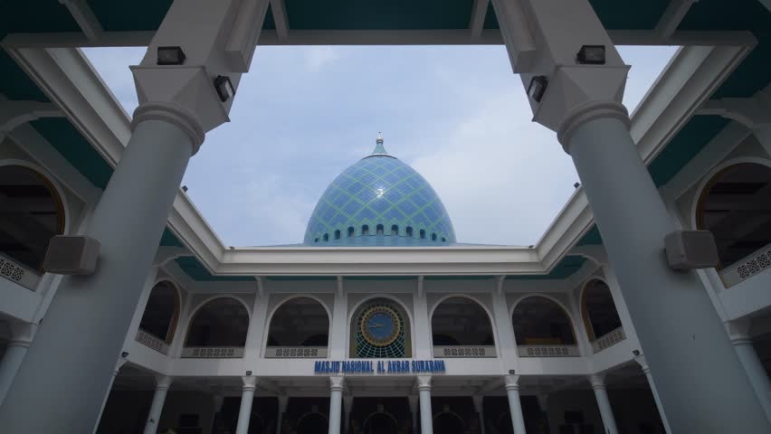 The blue circular dome of al-Akbar National Mosque Surabaya in Southeast Asia, Indonesia. The text translation that appears in the picture: al-Akbar National Mosque Surabaya.