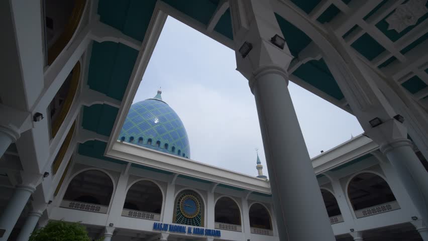 The blue circular dome of al-Akbar National Mosque Surabaya in Southeast Asia, Indonesia. The text translation that appears in the picture: al-Akbar National Mosque Surabaya.