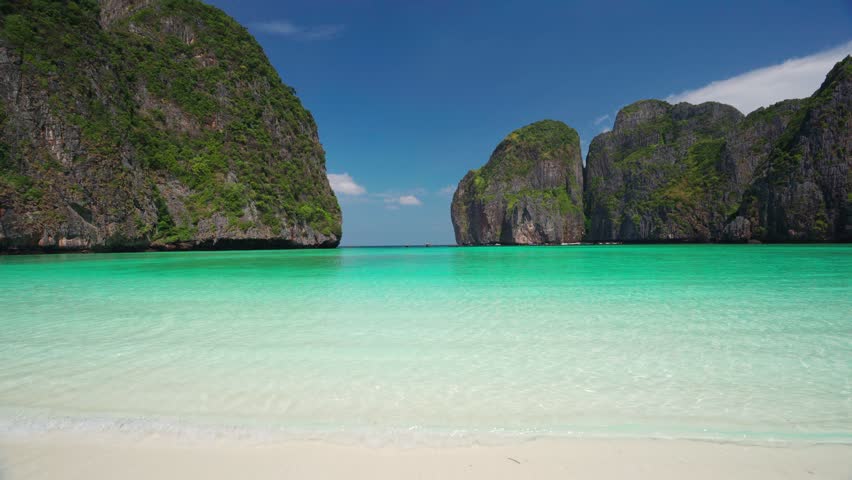 Young woman traveler relaxing and enjoying at beautiful tropical white sand beach at Maya bay in Krabi, Thailand, Summer vacation and Travel concept