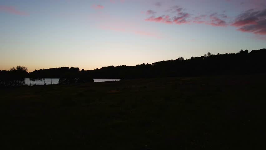 Aerial Drone Footage Over a Lake During Sunset