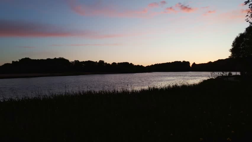 Aerial Drone Footage Over a Lake During Sunset