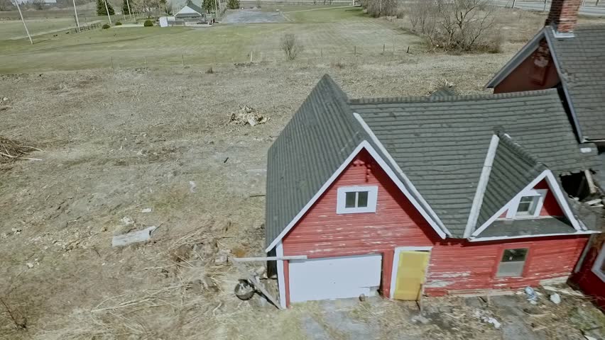 Abandoned farmhouse with crumbling roof waits to be torn down