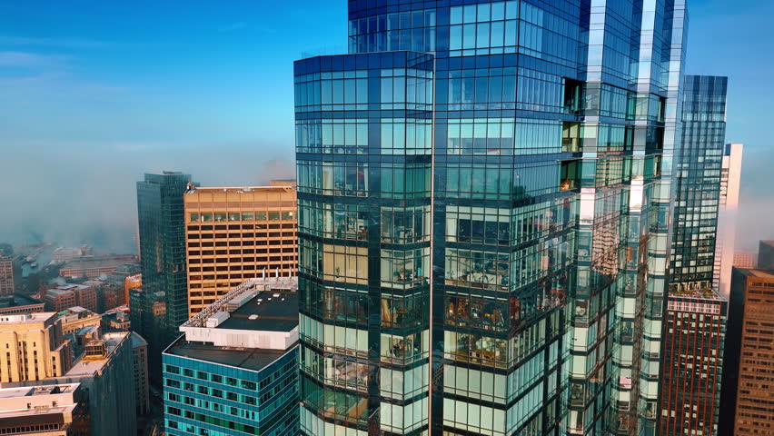 Modern towers of glass and metal. Smoke rises over the buildings in the downtown of Boston, Massachusetts, USA. Aerial view.