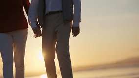 Elderly couple holding hands walking at sunset by the sea - Powered by Shutterstock - Get 15% off with code: PIKWIZARD15