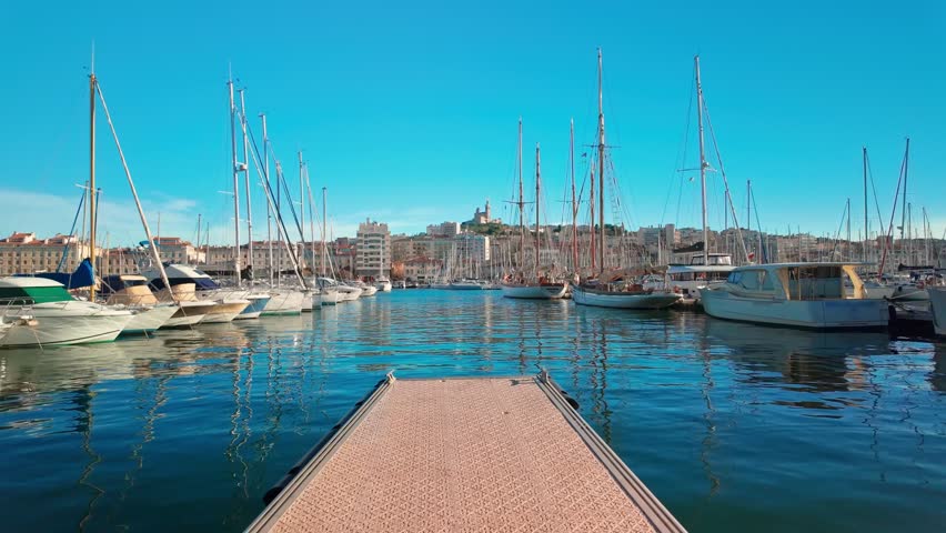 Marseille city skyline on a sunny day, France. Beautiful view of Vieux Port and Basilique Notre-Dame de la Garde on the French Riviera. 