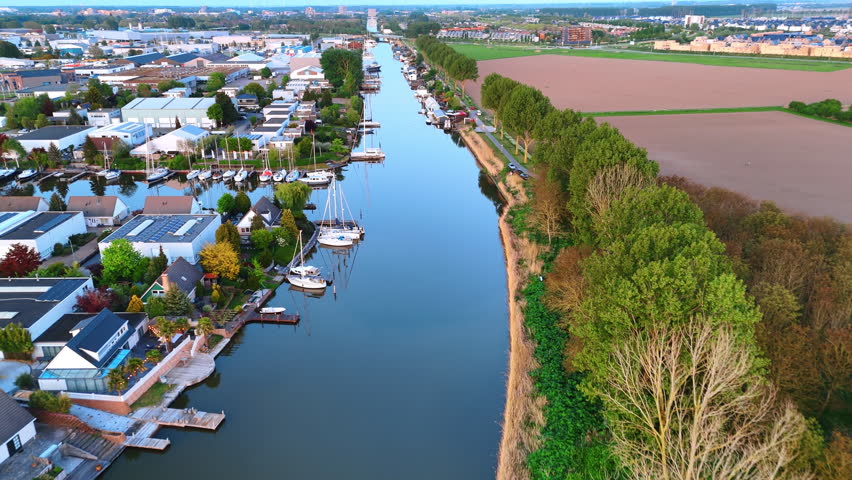 Blue sky reflecting in the smooth waterscape of the canal. Aerial perspective on Vinkeveen, the Netherlands.
