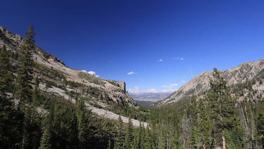 View from Petit Lake Trail in the Sawtooth Wilderness, looking east toward the White Cloud Mountains on a clear summer day. Static Shot.