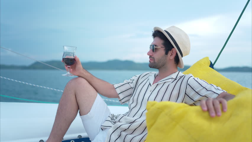 A young man is enjoying his seaside adventure aboard a yacht