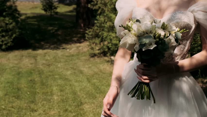  bride holds a wedding bouquet in her hands	
