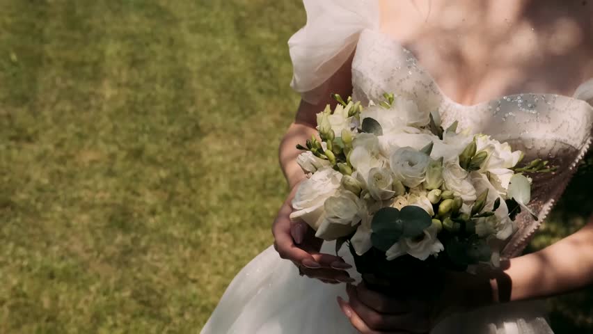  bride holds a wedding bouquet in her hands	