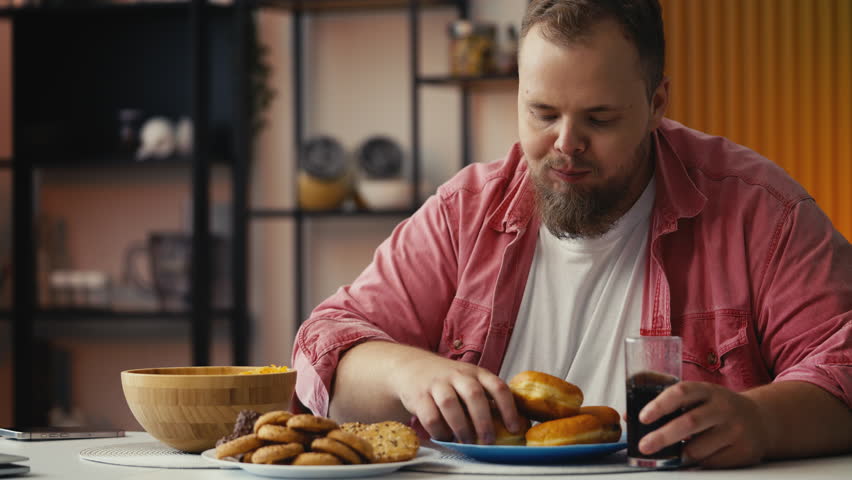 Plus-size man eating food high in added sugar, struggling with overeating habits
