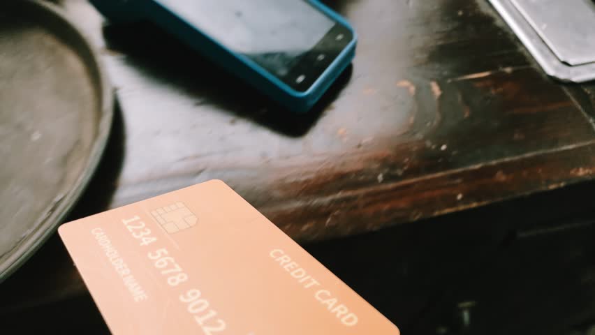 Close up POV shot of a seller processing a credit card transaction on an EDC machine