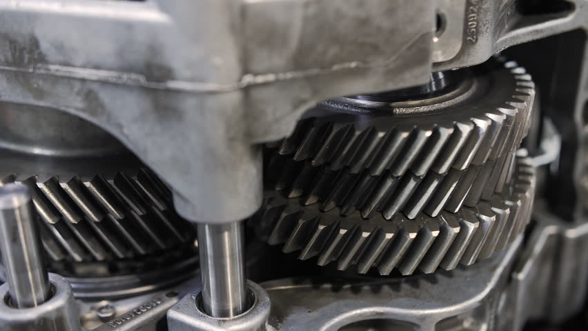 Close-up of metal gears inside car transmission system