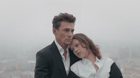 A couple shares a deeply tender moment in a foggy city, beautifully showcasing their profound intimacy and connection - Powered by Shutterstock - Get 15% off with code: PIKWIZARD15