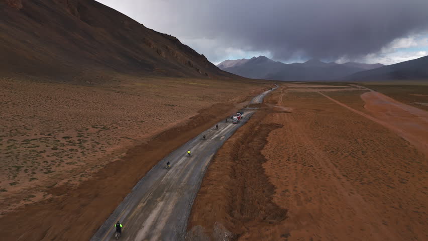 Motorcyclists Passing Trucks on Mountain Road