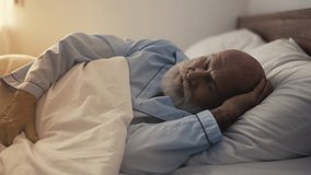 Elderly bearded man deeply asleep in comfortable bed, health and restful night - Powered by Shutterstock - Get 15% off with code: PIKWIZARD15