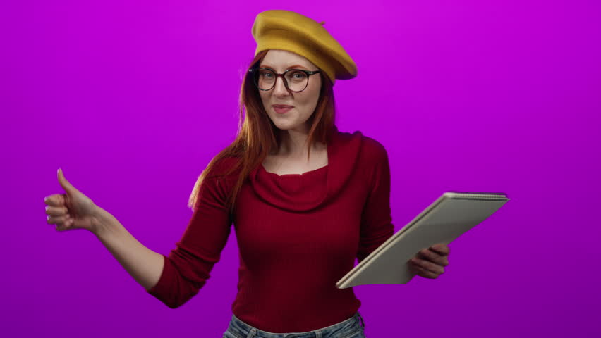 Woman redhead smiling holding notebook wearing beret pink background creative isolated beautiful adult glasses art passion stylish joyful energetic vibrant appearance.