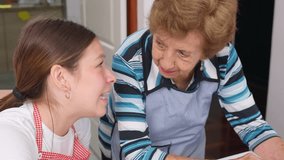 Elderly woman wearing apron teaching young girl cupcake decorating techniques, sharing sweet family moment with love and joy in home kitchen - Powered by Shutterstock - Get 15% off with code: PIKWIZARD15