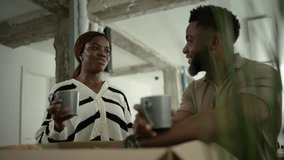 Coworkers taking a break, sipping coffee and chatting amidst moving boxes in a new office space - Powered by Shutterstock - Get 15% off with code: PIKWIZARD15