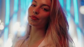Close-up portrait of a beautiful woman with long hair in the city at night with neon lights. The vibrant colors and urban setting create a modern and stylish atmosphere. Beautiful Woman In The City - Powered by Shutterstock - Get 15% off with code: PIKWIZARD15