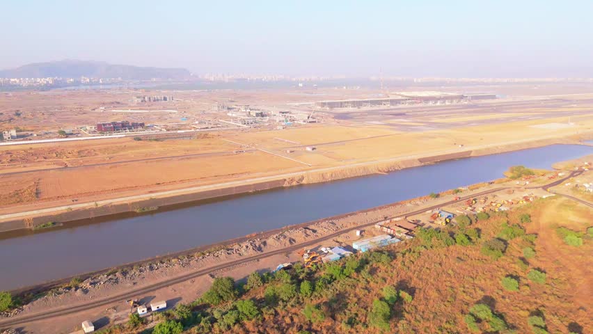 Aerial Perspective of Airfield Build with Waterway, Birds Eye View of Expanding Aviation Zone Beside Creek, Adjacent, Construction Progress at Aerodrome Next to Flowing Channel, Site Close to Riverbed
