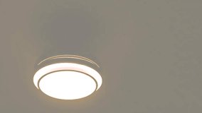 Ceiling lamp light on and hanging in a room. electrical appliances 4k video footage. - Powered by Shutterstock - Get 15% off with code: PIKWIZARD15