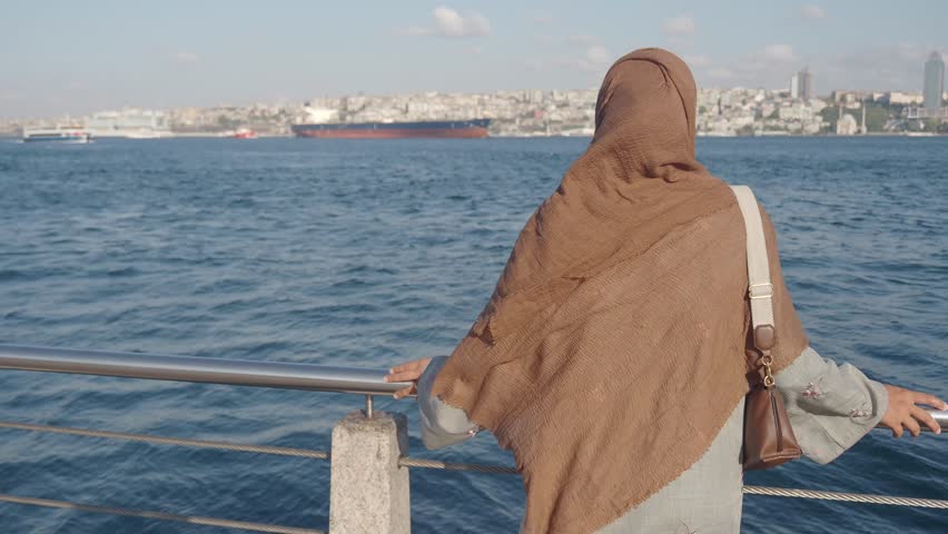 A Woman Gazing Delicately at the Serene Seascape in a Scenic City View