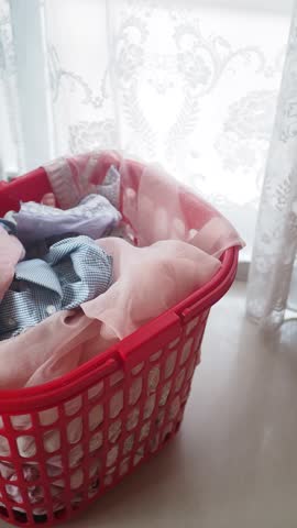A Colorful Laundry Basket Filled with Soft and Cozy Fabrics of Various Colors