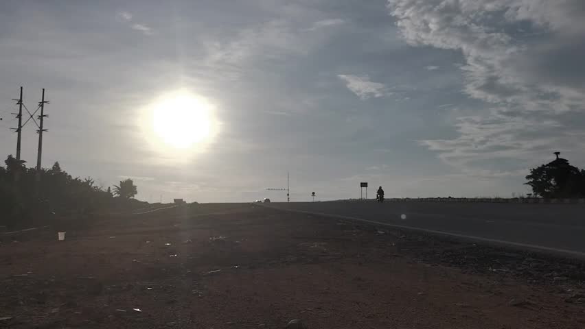 Silhouettes on a Rural Road at Sunset