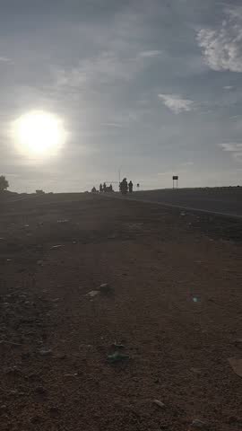 Silhouettes on a Rural Road at Sunset