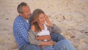 Romantic middle-aged couple enjoying a peaceful evening together on the beach. Love, connection, and togetherness concept for mature relationships and slow living lifestyle. - Powered by Shutterstock - Get 15% off with code: PIKWIZARD15