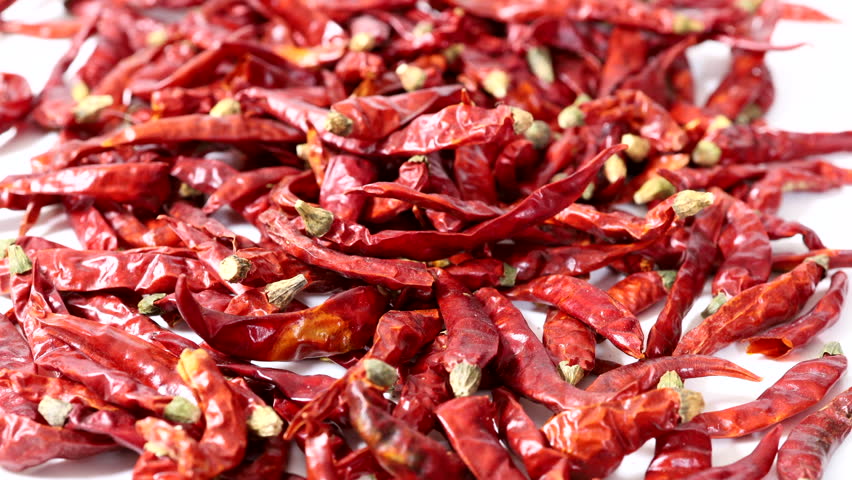Dolly closeup shot of Dried Red hot chili peppers.Showcasing Their Wrinkled Texture and vivid color of hot and spicy.
