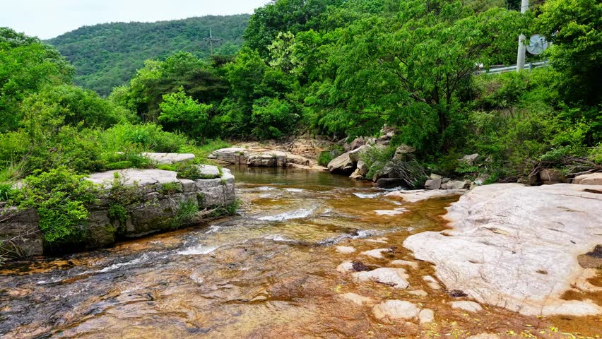 Aerial Drone Footage of a Clear Mountain Stream Flowing Through Mungyeong Countryside in Late Spring and Early Summer, Korea