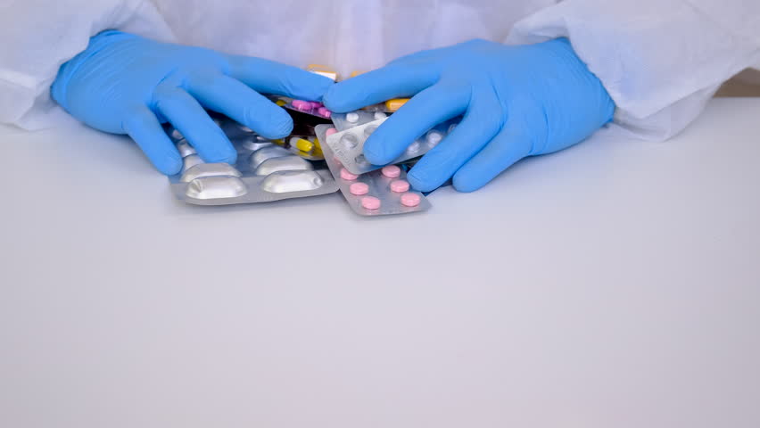 Doctor with medicines in his hands. Selective focus.