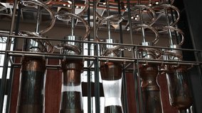 Chrome spiral tubes curl around tall transparent cylinders filled with roasted coffee beans creating a mesmerizing visual rhythm inside a futuristic artisanal roasting station - Powered by Shutterstock - Get 15% off with code: PIKWIZARD15