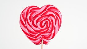 Red Colorful Spiral Lollipop Video Rotation. Sweet Caramel Candy on a Stick is spinning. Confectionery Theme. Round Twisted Sweets in Heart Shaping - Powered by Shutterstock - Get 15% off with code: PIKWIZARD15