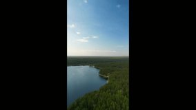 vertical video of a flight over a lake in a forest among trees. Forest lake on a summer day - Powered by Shutterstock - Get 15% off with code: PIKWIZARD15