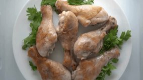 Roasted chicken drumsticks with parsley garnishing placed elegantly on a white plate - Powered by Shutterstock - Get 15% off with code: PIKWIZARD15