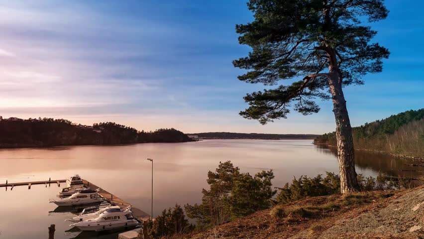 Serene Sunset Landscape with Boats Docked at Lakeside Marina