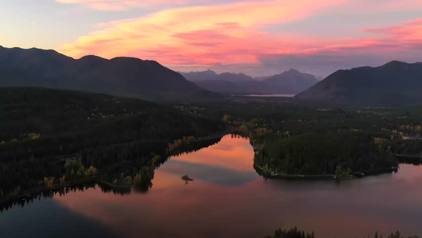 dramatic sunset sky over june lake during autumn in glacier national park montana